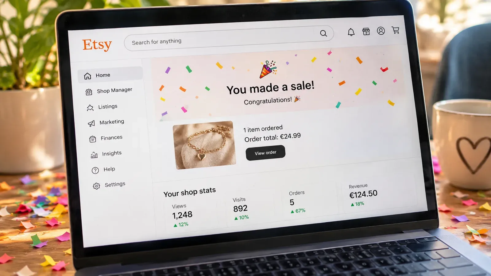 celebratory laptop showing first Etsy sale notification