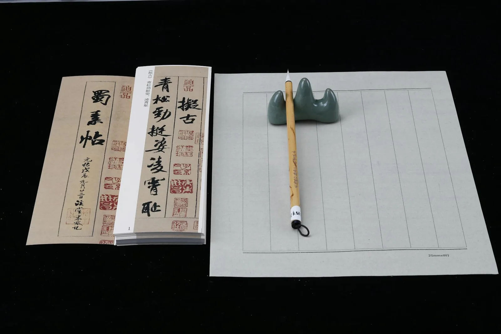 Elegant setup of traditional Chinese calligraphy tools featuring brushes, paper, and a holder.