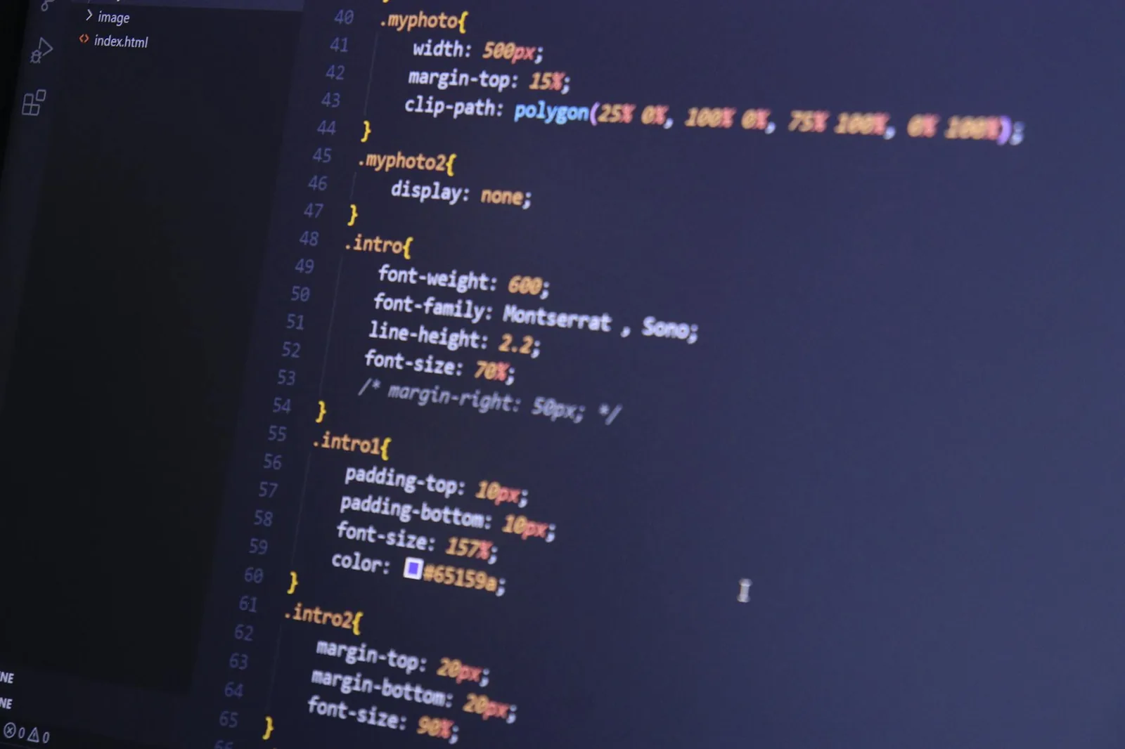 Focused shot of HTML and CSS code on a monitor for web development.